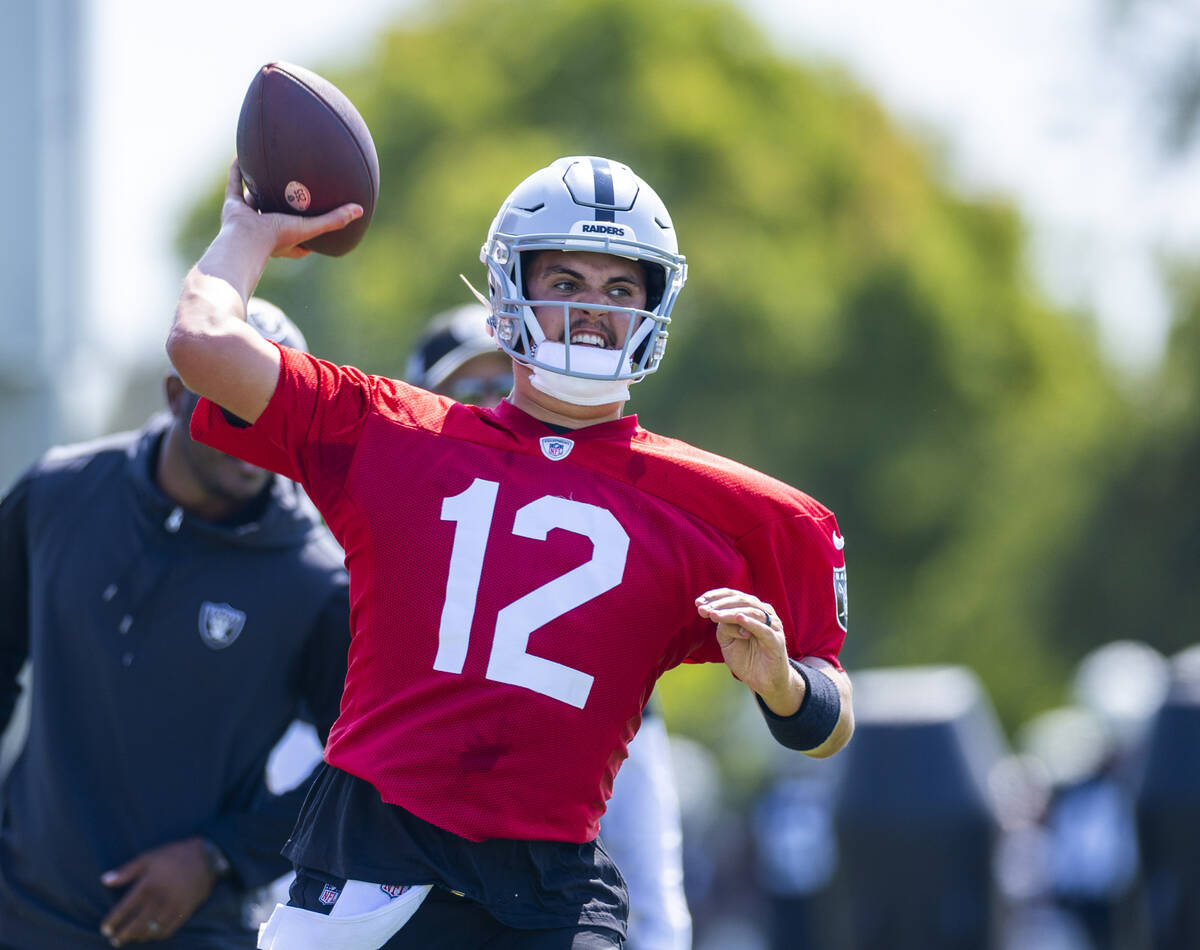 Raiders quarterback Aidan O'Connell (12) looks to pass during the first day of training camp at ...