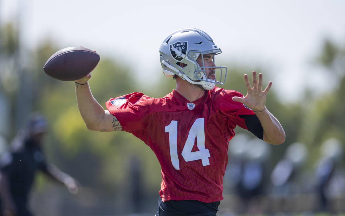 Raiders quarterback Carter Bradley (14) looks to pass during the first day of training camp at ...