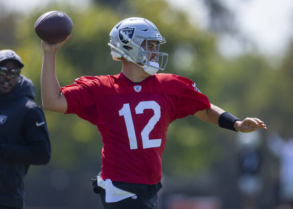 Raiders quarterback Aidan O'Connell (12) eyes a receiver during the first day of training camp ...