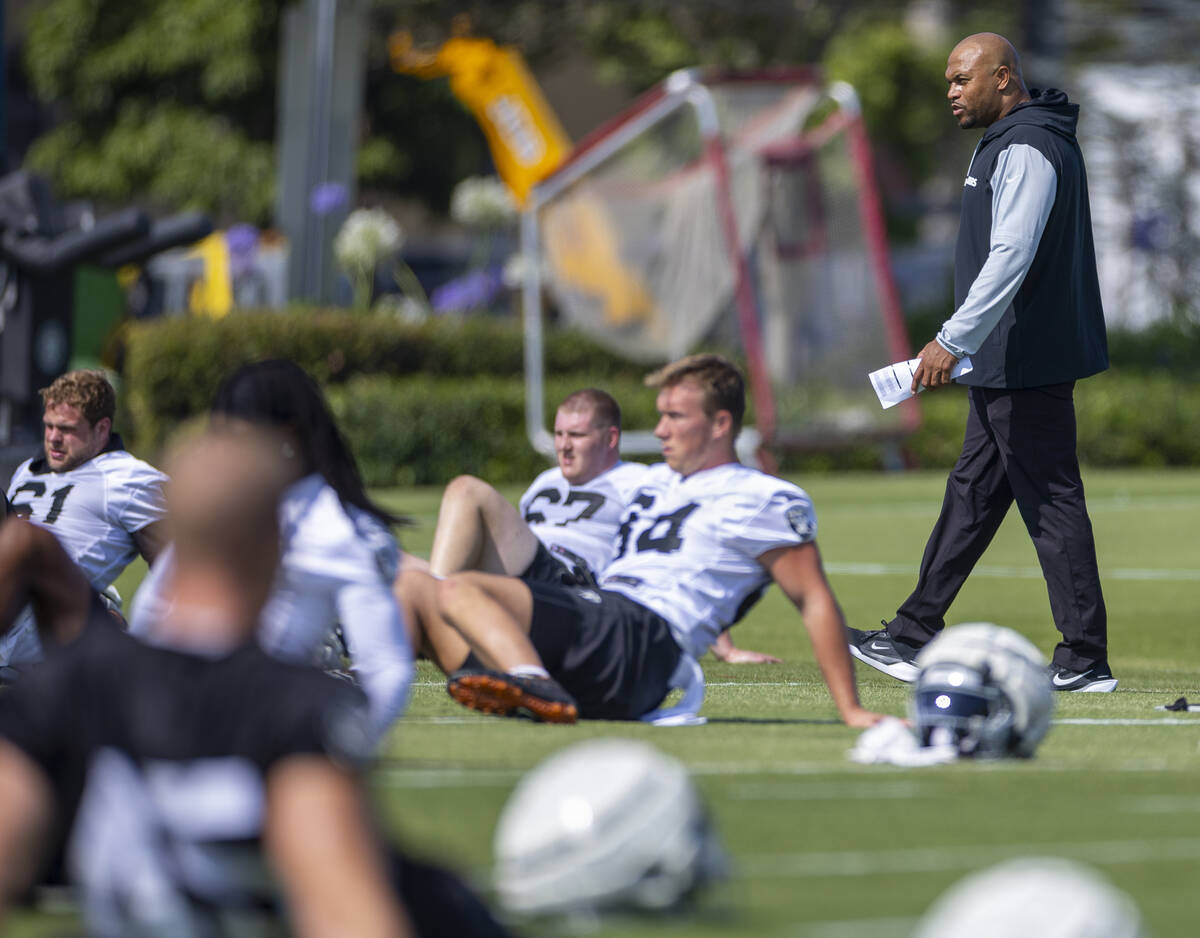 Raiders head coach Antonio Pierce walks about his players during the first day of training camp ...