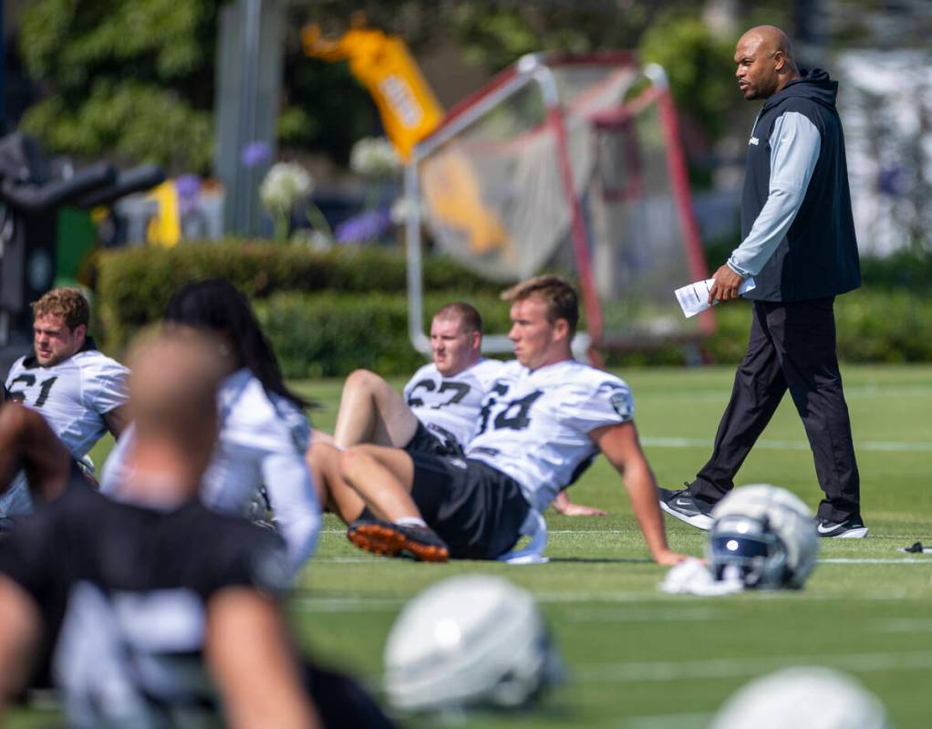 Raiders head coach Antonio Pierce walks about his players during the first day of training camp ...