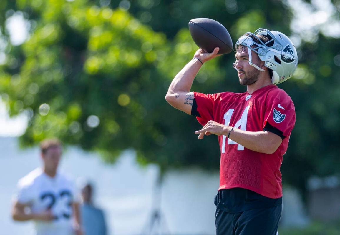 Raiders quarterback Carter Bradley (14) tosses the ball to a teammate during the first day of t ...