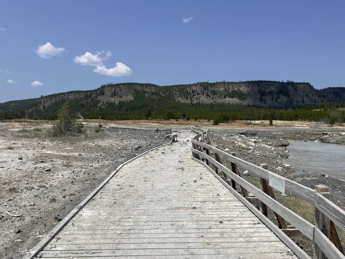 In this photo released by the National Park Service, debris litter the damaged Biscuit Basin bo ...