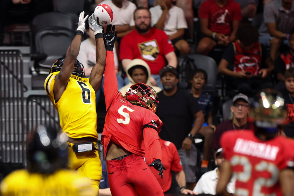 Vegas Knight Hawks defensive back Bryce Hampton (5) breaks up a touchdown pass intended for Tuc ...