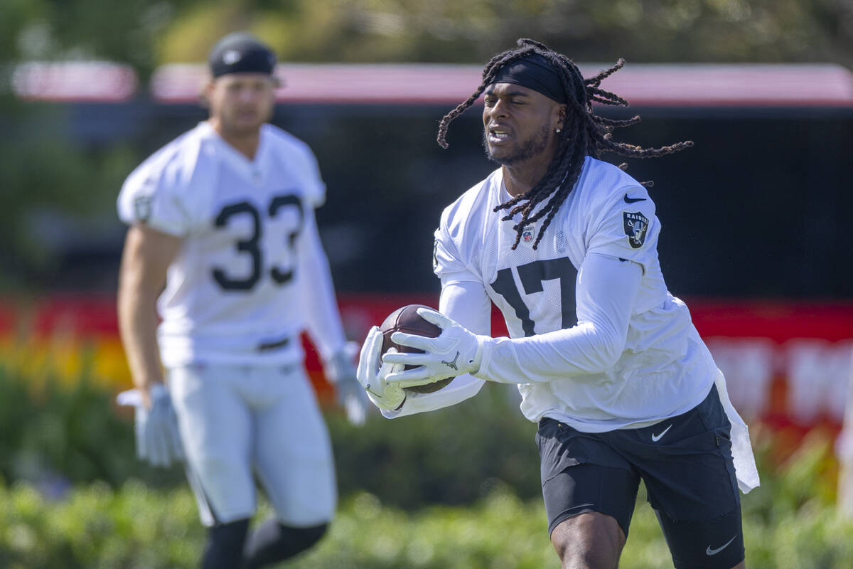 Raiders wide receiver Davante Adams (17) catches a pass during the first day of training camp a ...