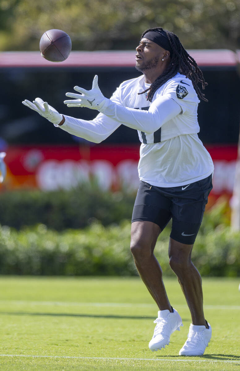 Raiders wide receiver Davante Adams (17) catches a pass during the first day of training camp a ...