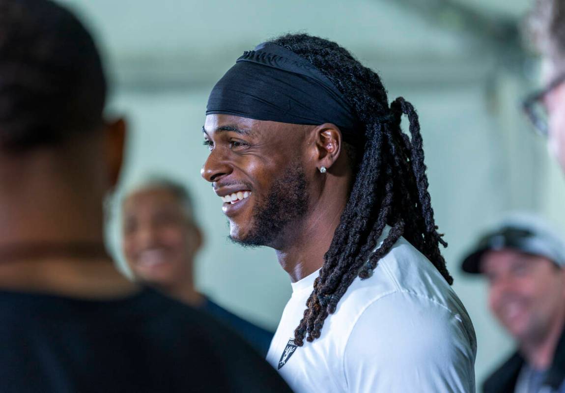 Raiders wide receiver Davante Adams (17) laughs at a question during a media interview on the f ...