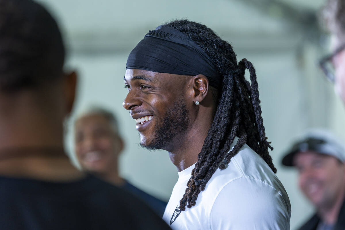 Raiders wide receiver Davante Adams (17) laughs at a question during a media interview on the f ...