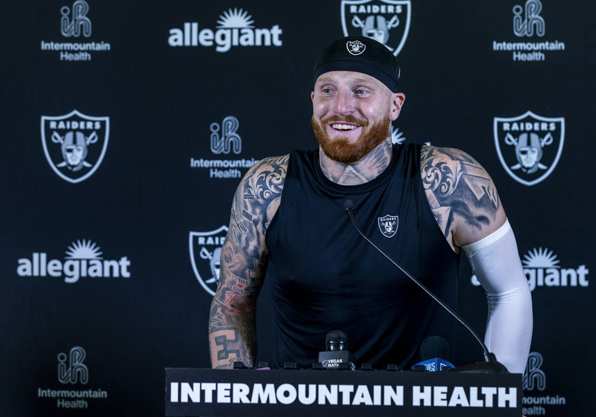 Raiders defensive end Maxx Crosby (98) smiles at a question during a media interview on the fir ...