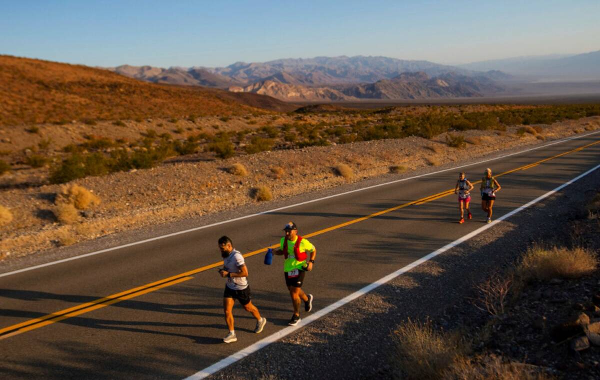 Runners start uphill at sunrise on California Route 190 during the Badwater 135 mile (217 kilom ...