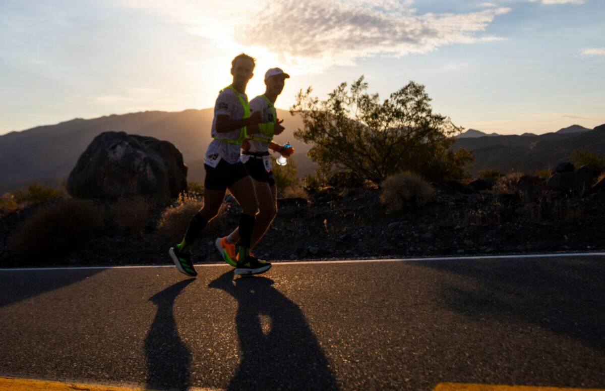 Ivan Penalba Lopez, left, from Spain, and his pacer run as the sun rises during the Badwater 13 ...