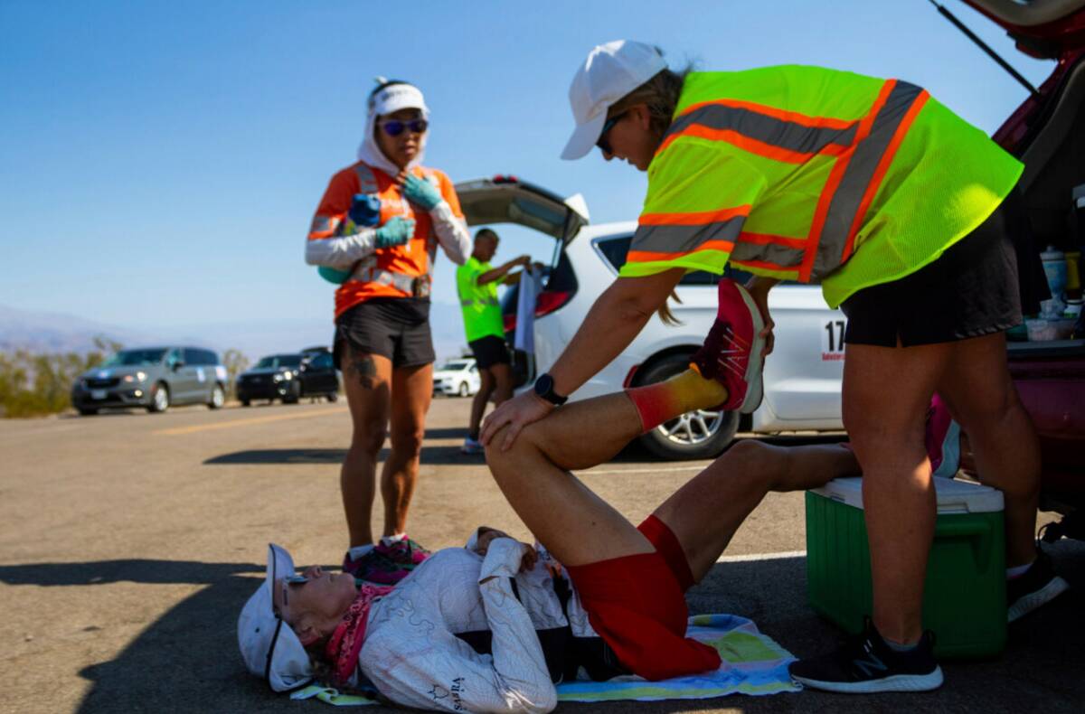 Karla Kent stretches during a brief pause along California Route 190 during the Badwater 135 mi ...