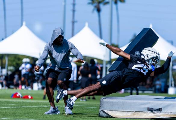 Raiders cornerback Decamerion Richardson (25) takes out a tackling pad on a drill during the se ...