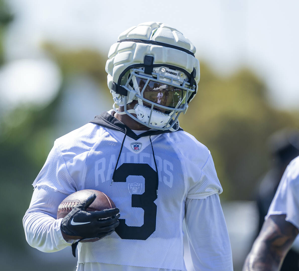 Raiders running back Zamir White (3) cradles a ball during the second day of Raiders training c ...