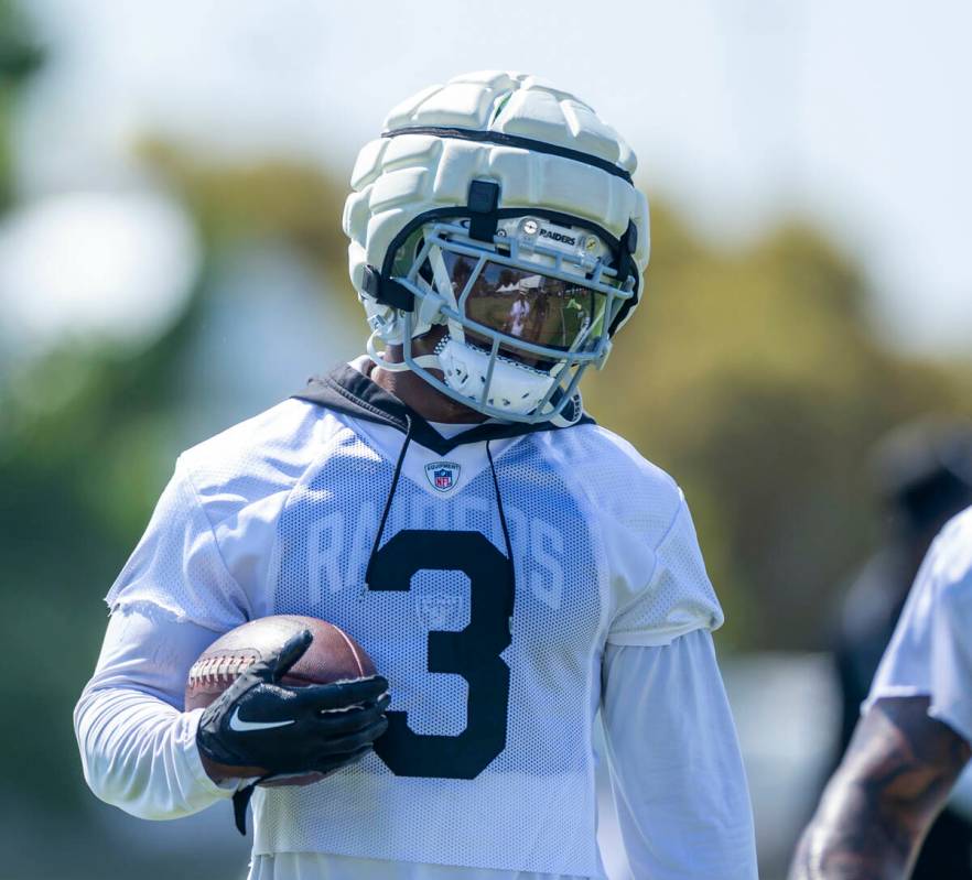 Raiders running back Zamir White (3) cradles a ball during the second day of Raiders training c ...