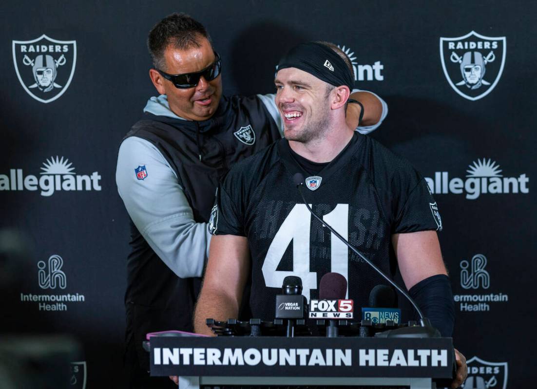 Raiders linebacker Robert Spillane (41) has a workout device removed by a staff member during a ...