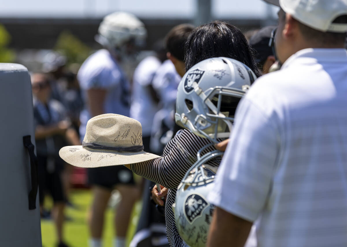 Raiders fans hope for autographs during the second day of Raiders training camp at the Jack Ham ...