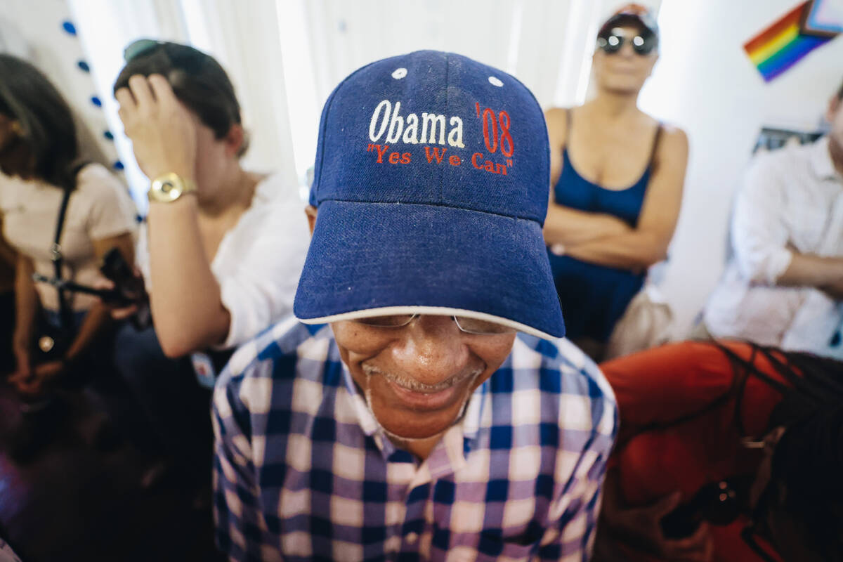 A supporter wears a Barack Obama campaign hat from his 2008 campaign during an event to officia ...
