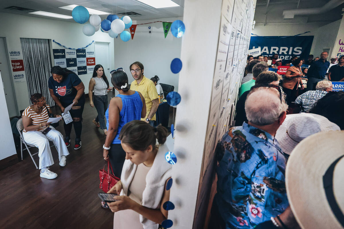 Volunteers and supporters speak to each other as an event to officially launch Vice president K ...