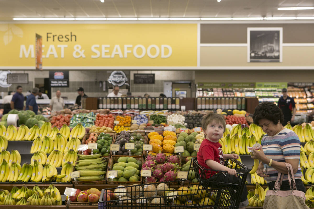 Customer Malenea Green, right, and her grandson Charlie make their way through the produce sect ...