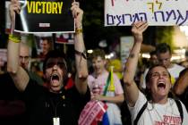 Holding signs with photos of Israeli hostages and demanding their release, people react as they ...