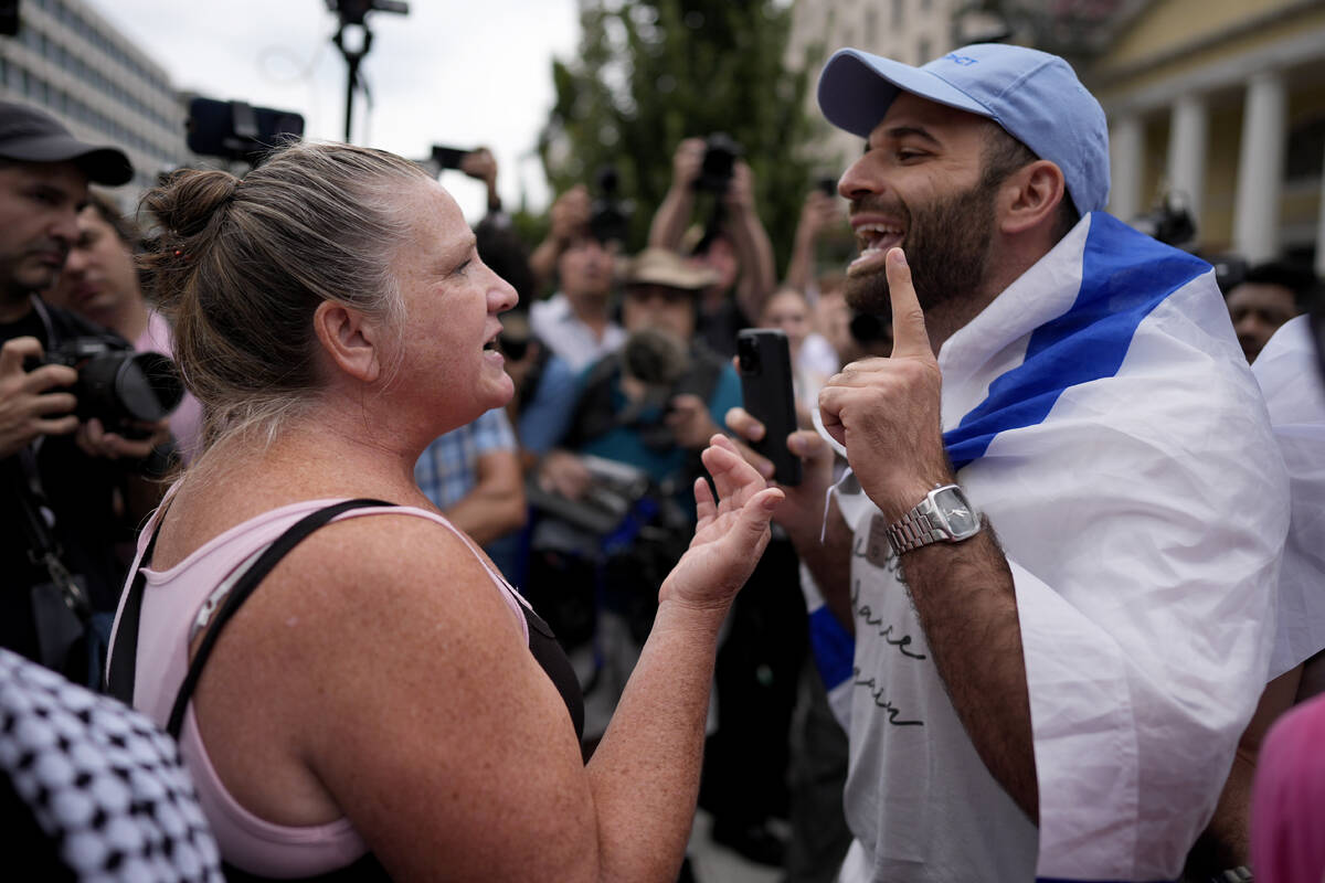 A pro-Israel demonstrator, right, clashes with Hasidic Jews and others as they protest Israeli ...