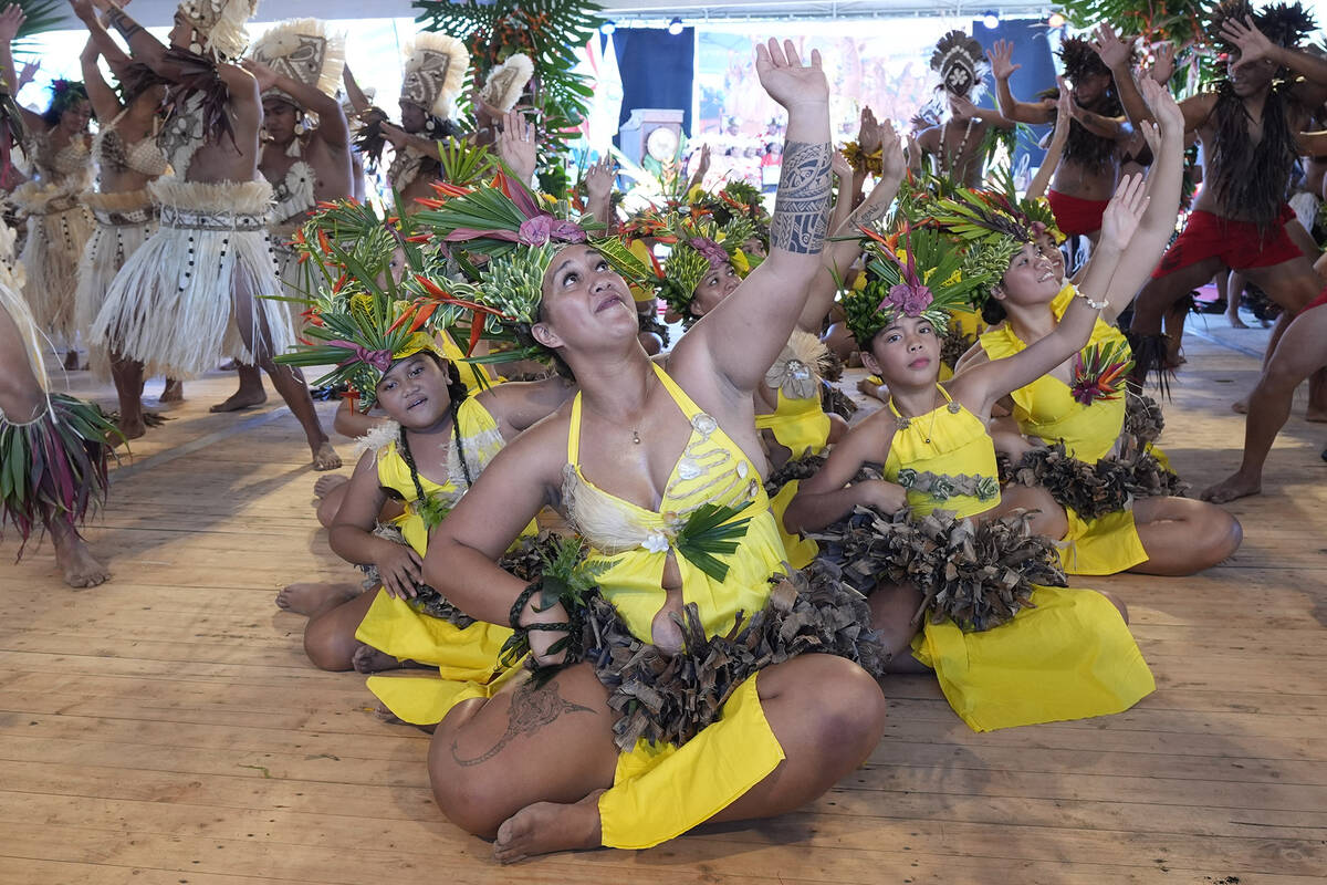 Dancers perform during an opening ceremony for the 2024 Summer Olympics surfing competition Fri ...