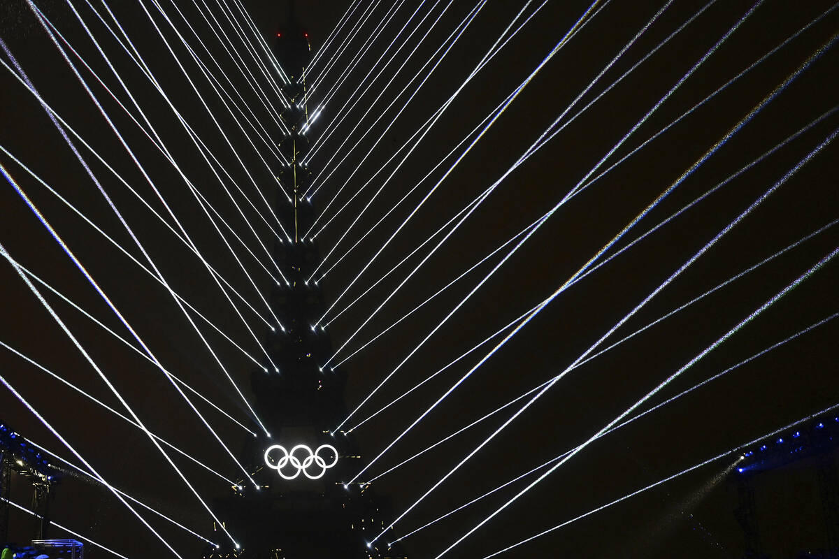 Lights emanate from the Eiffel Tower at the Trocadero during the opening ceremony for the 2024 ...