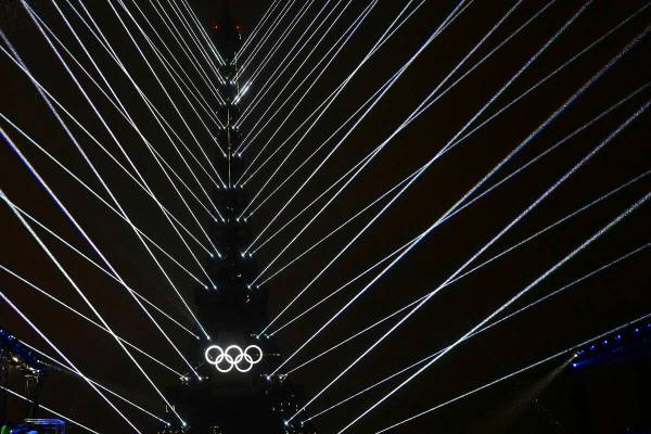 Lights emanate from the Eiffel Tower at the Trocadero during the opening ceremony for the 2024 ...