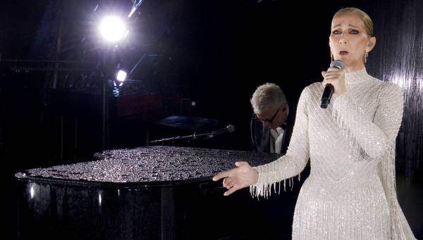This photo released by the Olympic Broadcasting Services shows Canadian Singer Celine Dion perf ...