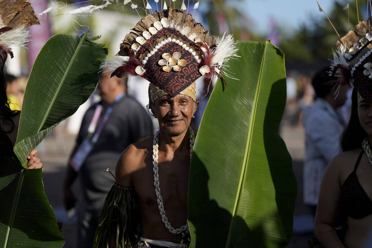 Dancers look on during an opening ceremony for the 2024 Summer Olympics surfing competition Fri ...