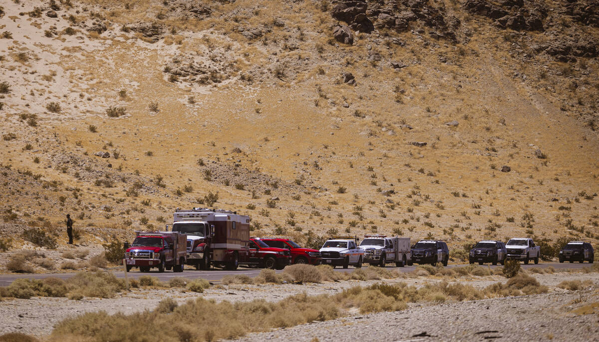 Law enforcement agencies vehicles are seen gathered by the scene of an overturned truck fire ca ...