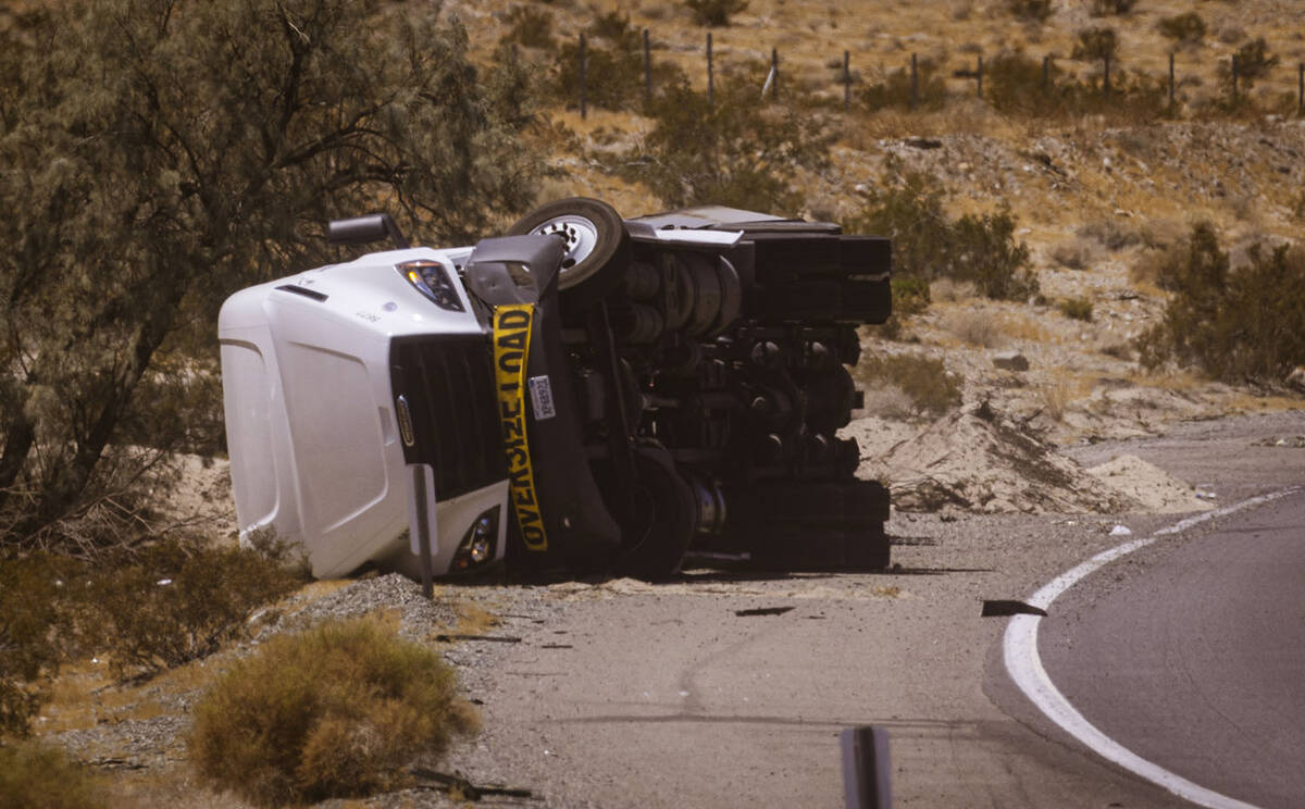 An overturned truck  carrying lithium-ion batteries that caught fire the day before is pic ...