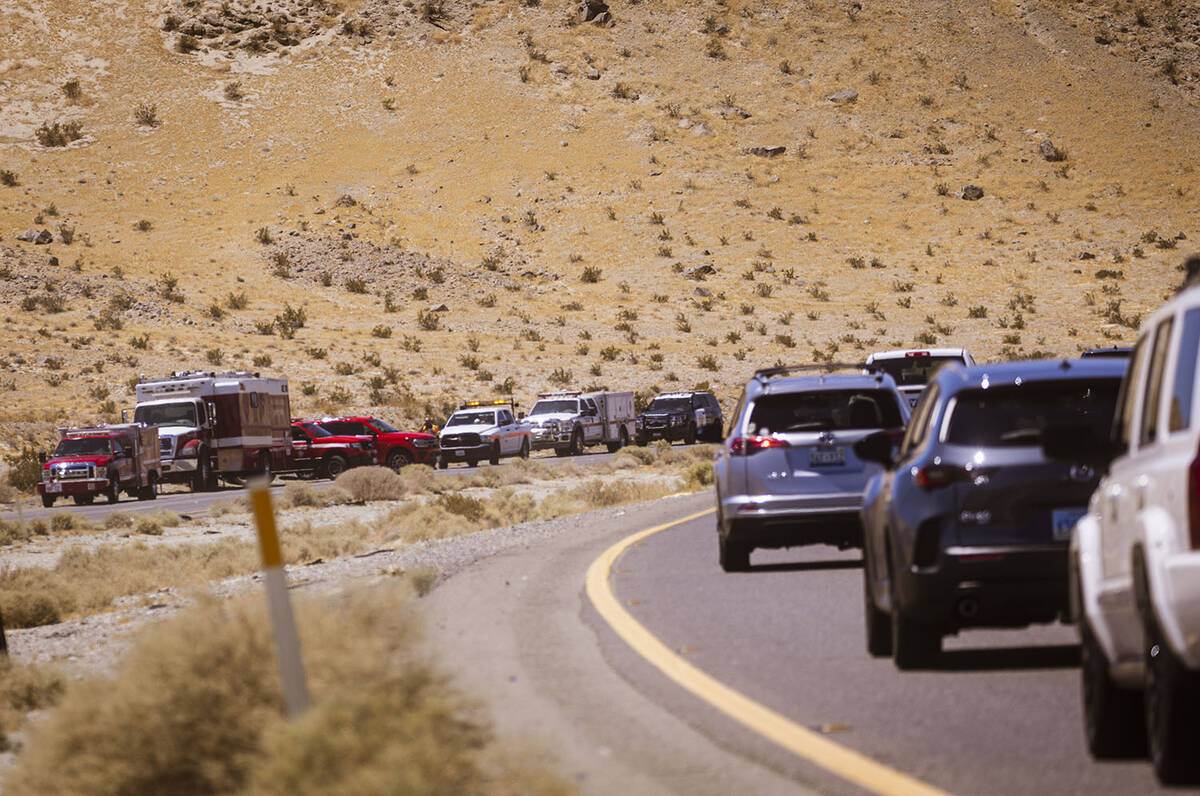 Law enforcement agencies vehicles are seen gathered by the scene of an overturned truck fire ca ...