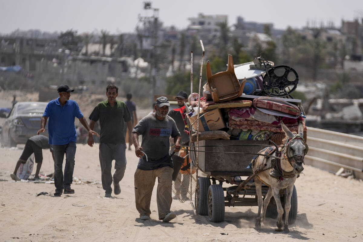 Palestinians displaced by the Israeli air and ground offensive on the Gaza Strip flee from part ...