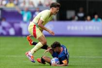 Spain's Pau Cubarsi, left, is fouled by Dominican Republic's Edison Azcona during the men's Gro ...