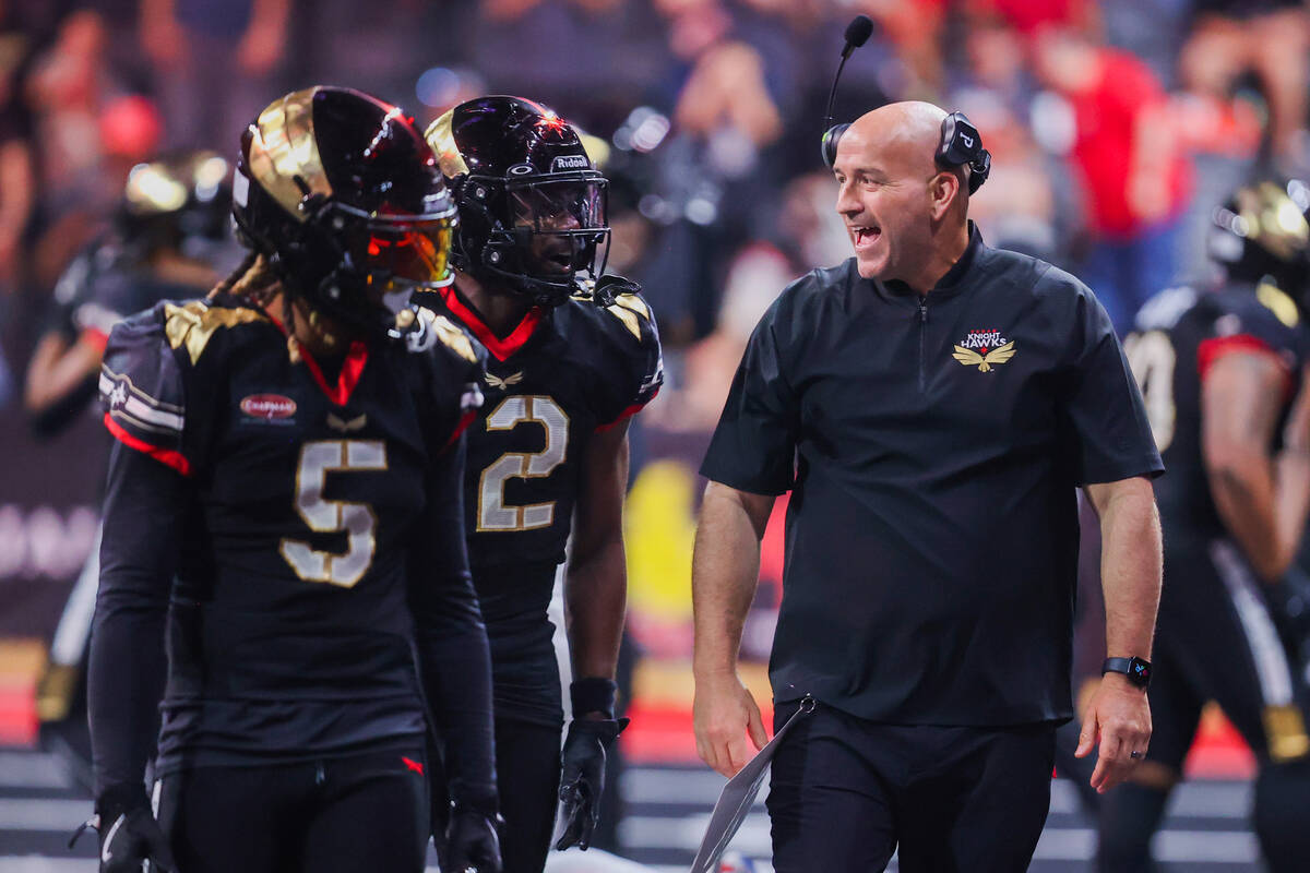 Knight Hawks head coach Mike Davis speaks to his players during a playoff game between the Knig ...