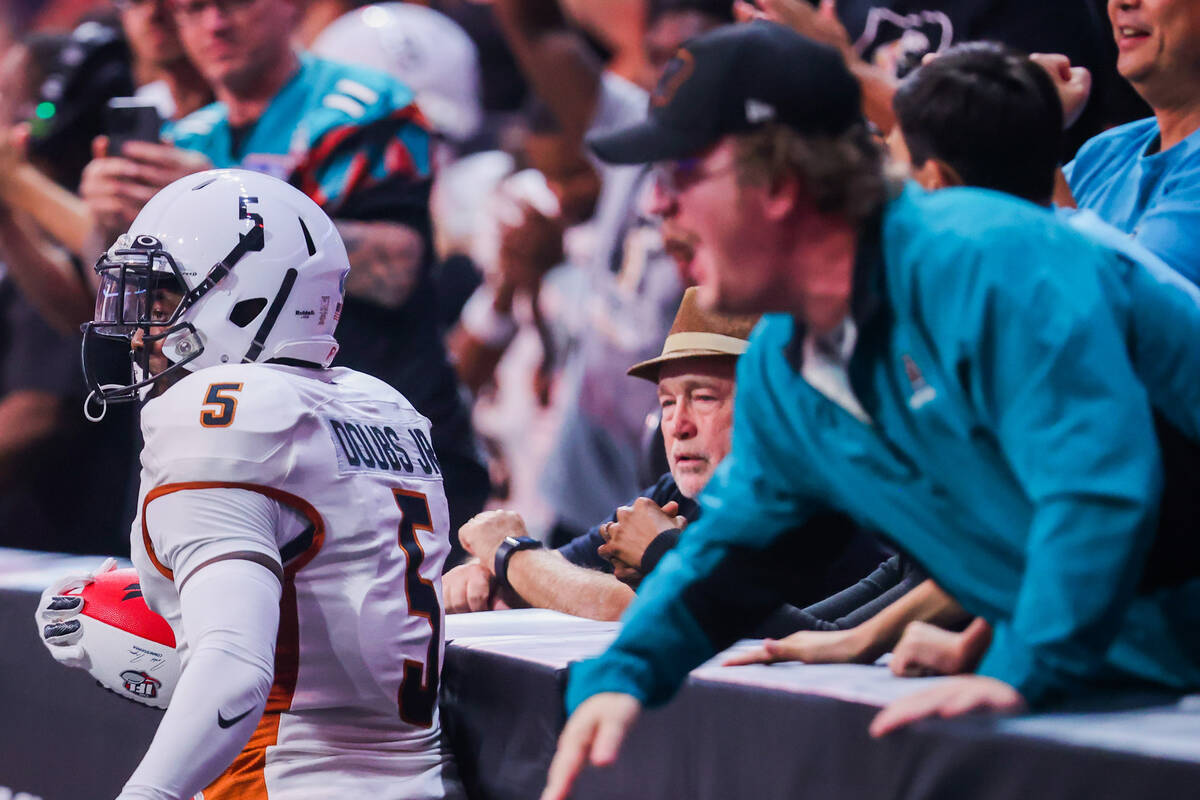 Fans cheer as Arizona Rattlers defensive back Jarmaine Doubs (5) keeps hold of the ball during ...