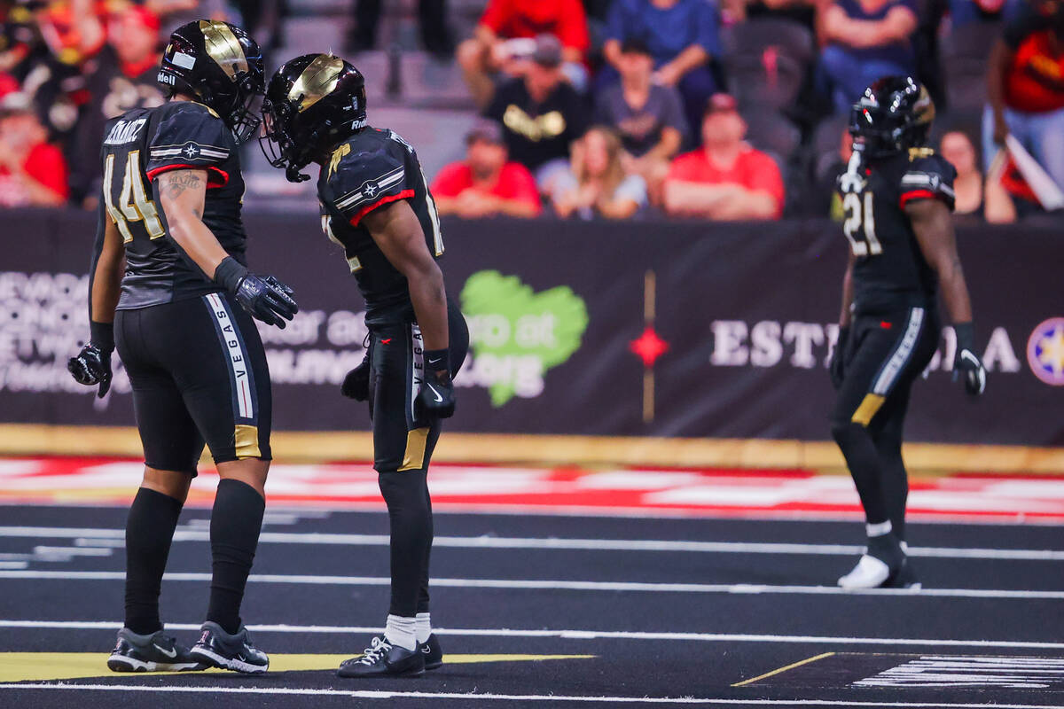 Knight Hawks defensive back James Ceasar and teammate Lorenzo Hernandez (44) celebrate during a ...