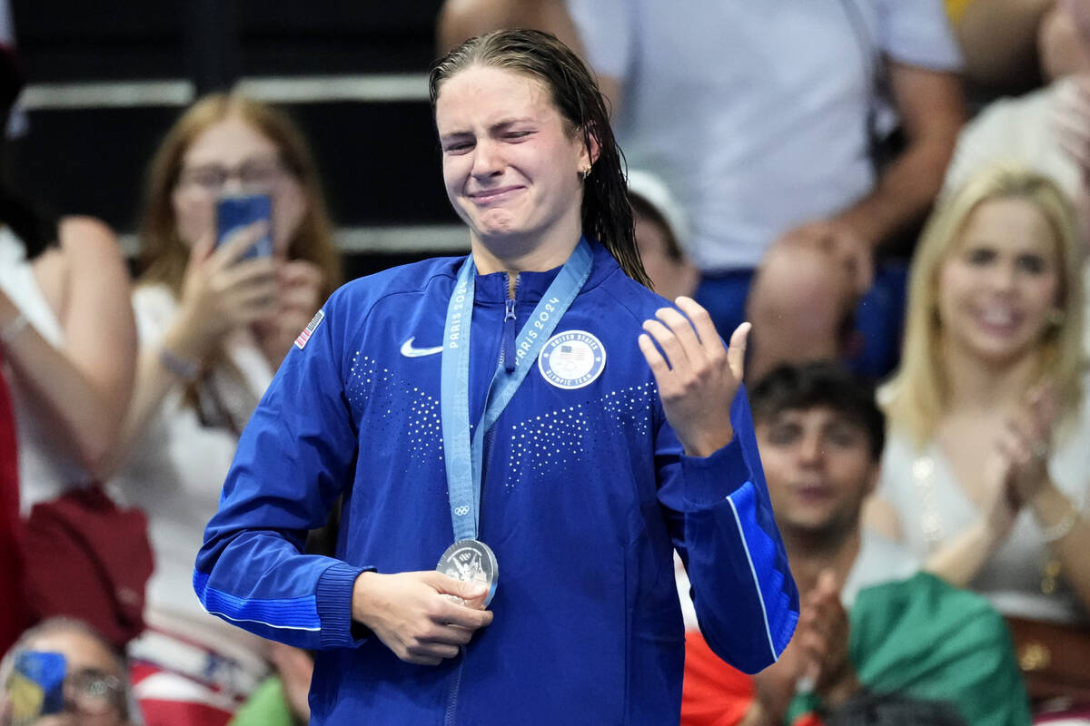 Silver medalist Katie Grimes, of the United States, reacts on the podium following the women's ...