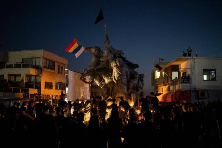 People light candles in memory of the children and teens killed in a rocket strike at a soccer ...