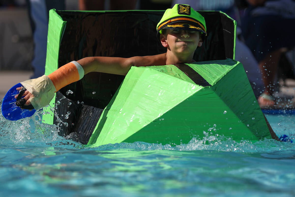 Archer Connors, 12, paddles against his opponent during the Cardboard Boat Regatta at Henderson ...