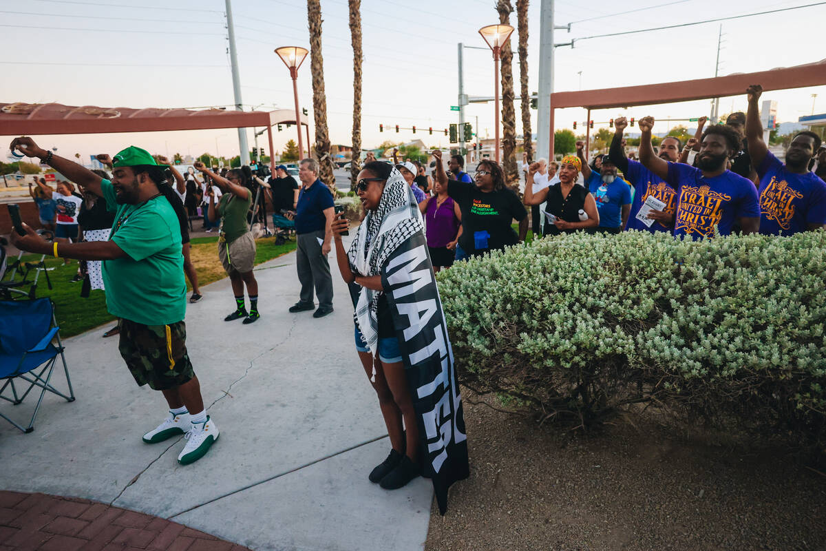 Mourners raise their fists during a vigil for Sonya Massey, a Black woman who was killed in her ...