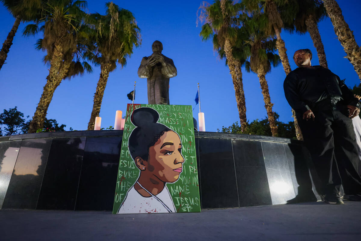 A painting of Sonya Massey sits in front of a statue of Martin Luther King Jr. during a vigil f ...