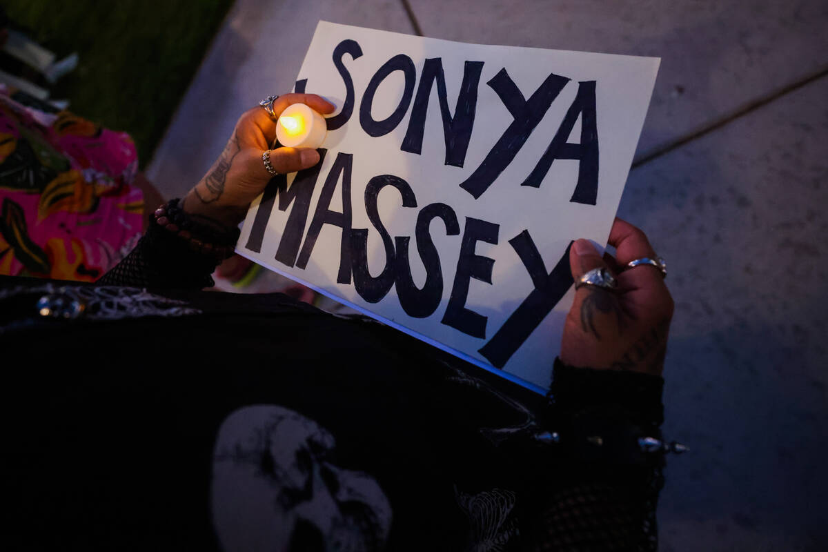 A mourner holds up a sign with Sonya Massey’s name on it during a vigil for Sonya Massey ...