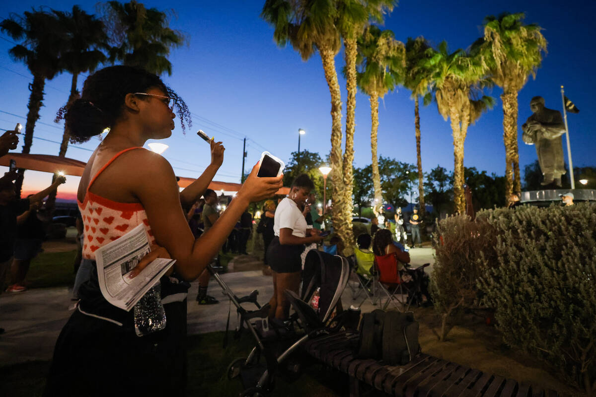 Mourners raise their phone flashlights to the sky during a vigil for Sonya Massey, a Black woma ...