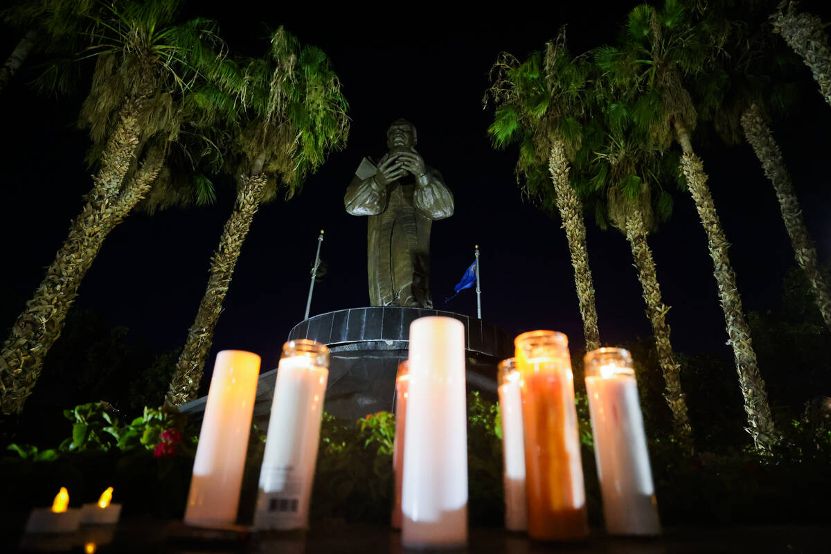 Candles are lit in front of a statue of Dr. Martin Luther King Jr. during a vigil for Sonya Mas ...