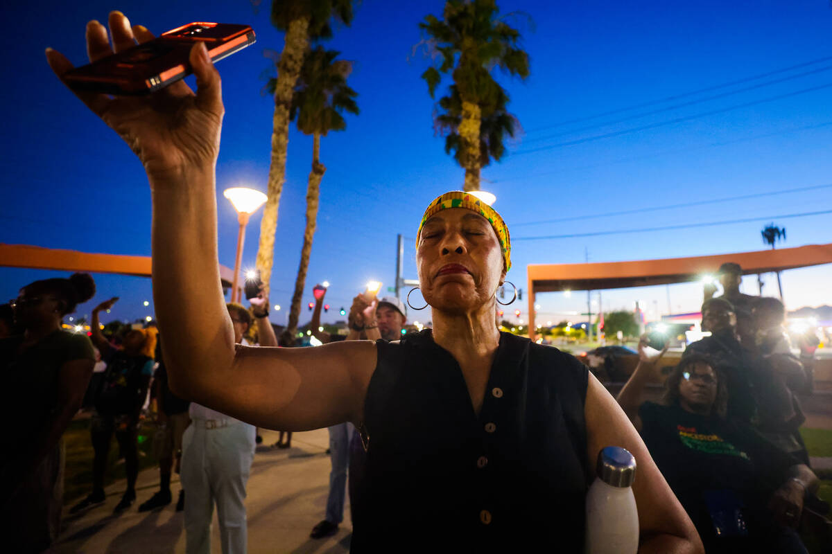 Mourners raise their phone flashlights to the sky during a vigil for Sonya Massey, a Black woma ...