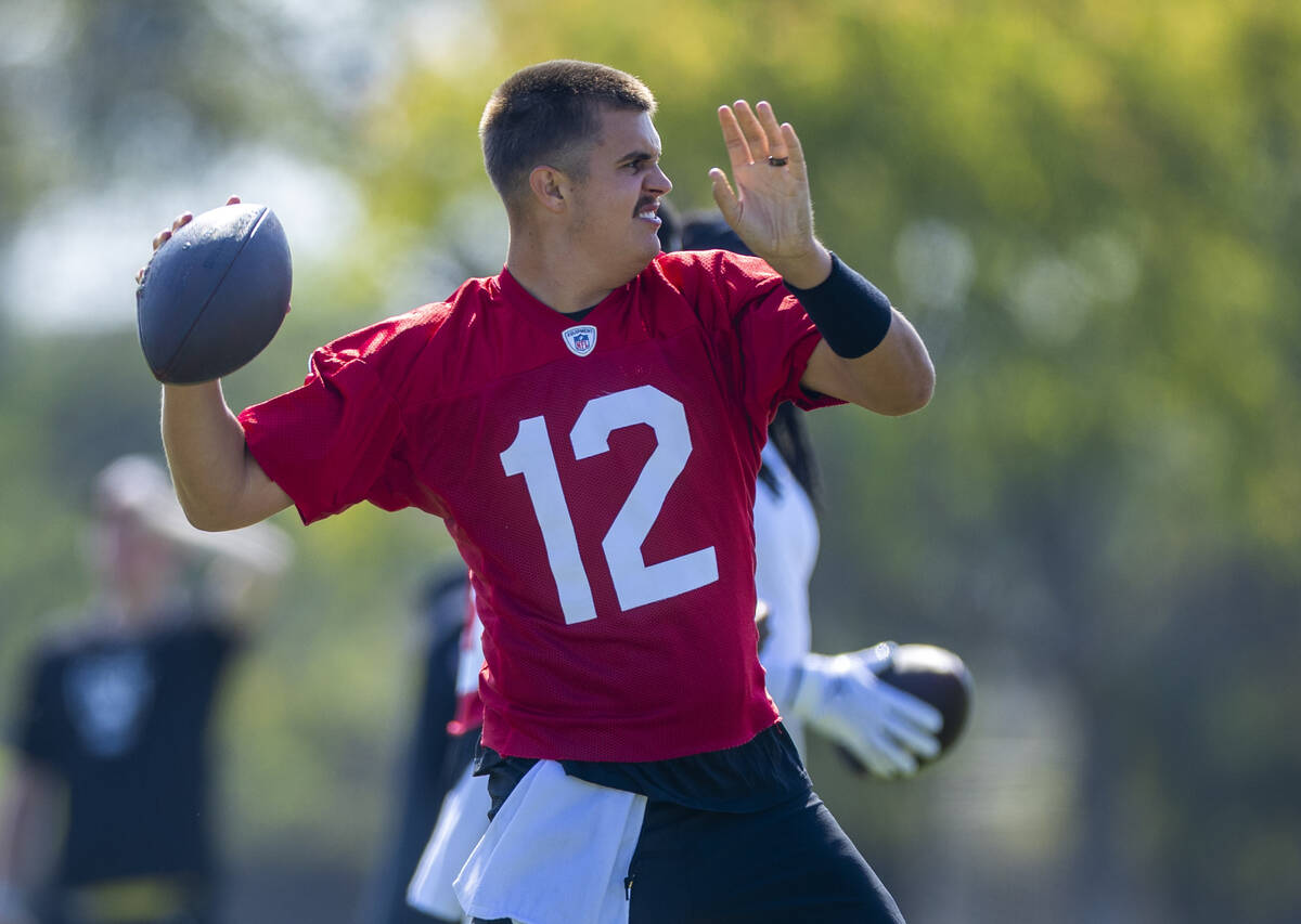 Raiders quarterback Aidan O'Connell (12) throws a pass during the second day of Raiders trainin ...