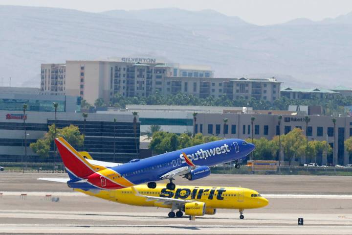 A Southwest Airlines jet takes off as a Spirit Airlines jet taxis at Harry Reid International A ...